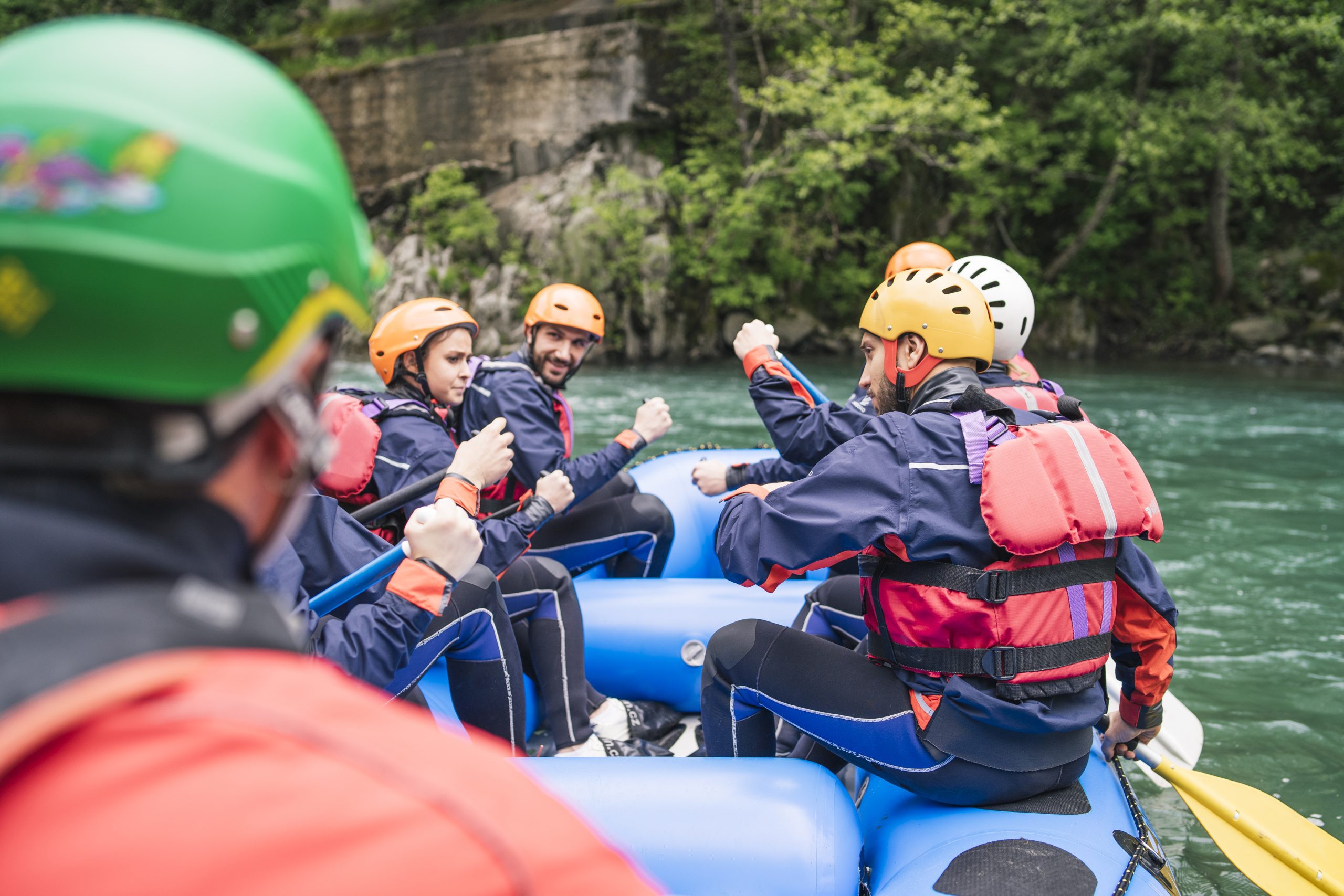Group of people rafting in rubber dinghy on a river Group of people rafting in rubber dinghy on a river