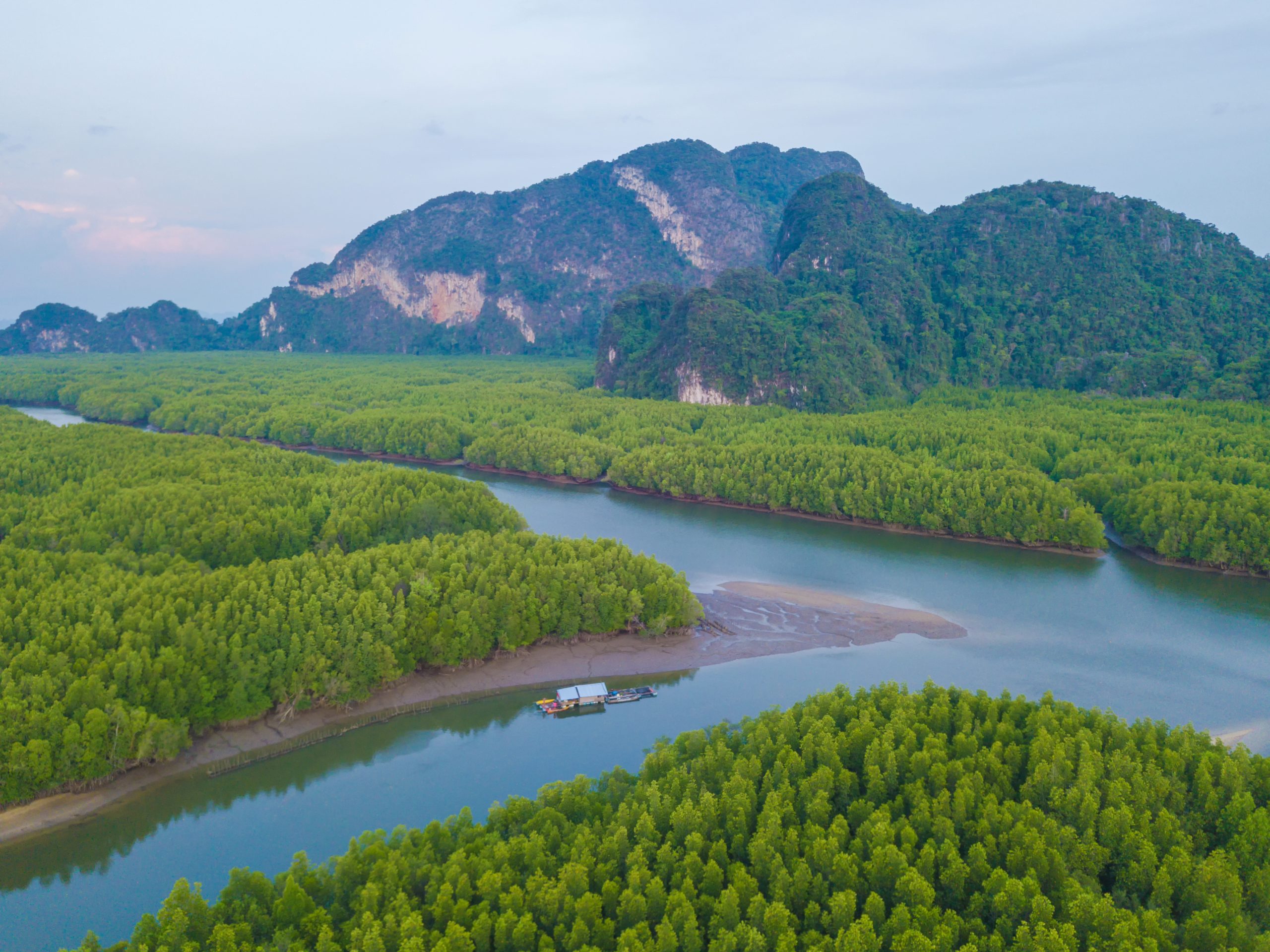 Aerial top view of Samet Nangshe, mountain valley hills, and tropical green forest trees at sunset with Andaman sea in Phang Nga Bay in summer, Thailand in travel trip. Natural landscape background. Aerial top view of Samet Nangshe, mountain valley hills, and tropical green forest trees at sunset with Andaman sea in Phang Nga Bay in summer, Thailand in travel trip. Natural landscape background.