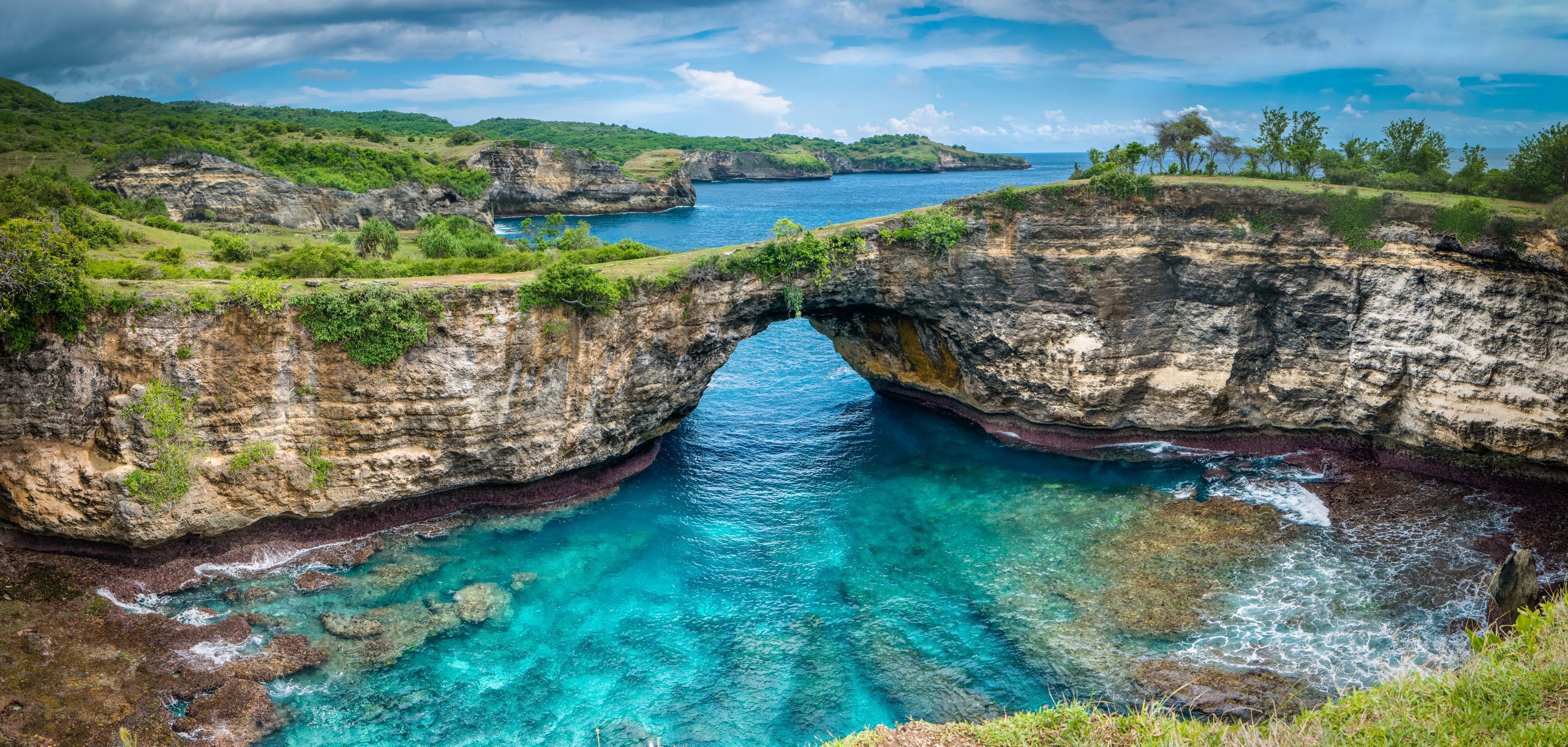 Stone arch over the sea. Broken beach, Nusa Penida ,Indonesia. Rock coastline of Nusa Penida. Stone arch over the sea. Broken beach, Nusa Penida,Indonesia